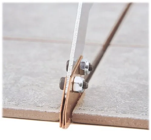 Grout grabber removing grout.