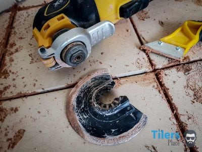 Oscillating tool with a deals grout removal blade